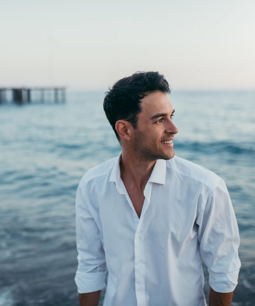 man in white shirt on the beach