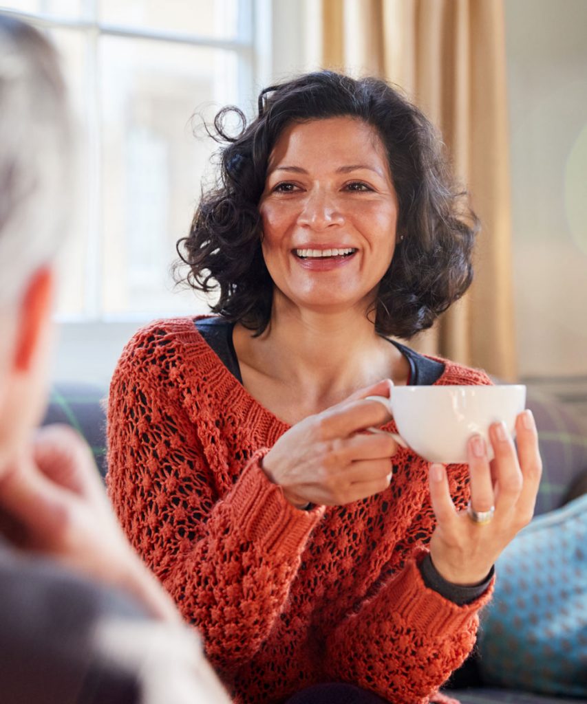 Middle aged woman drinking coffee