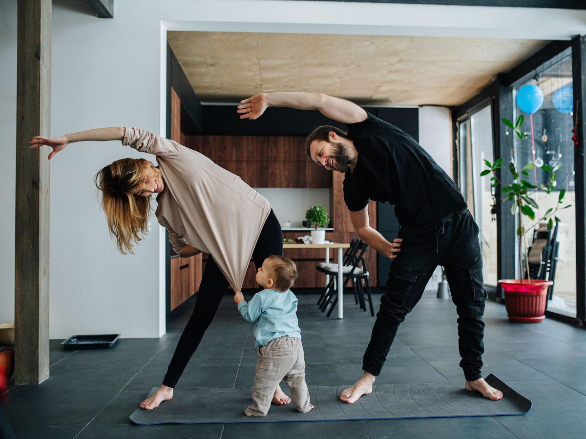 family with infant child doing yoga